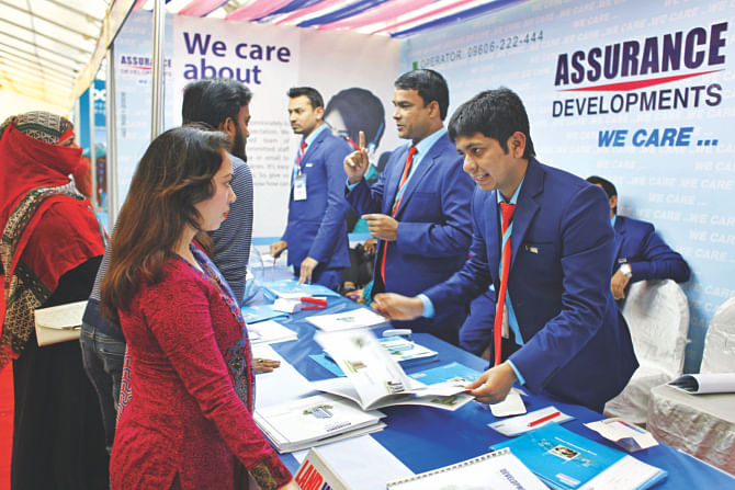 Visitors check out a stall of Assurance Developments on the second day of a real estate fair at Bangabandhu International Conference Centre in Dhaka yesterday.  Photo: Star 