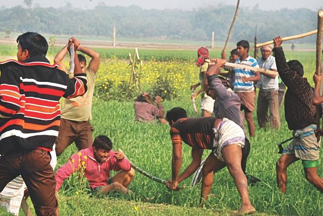 Opposition activists attack two men, who “dared” to go to a polling station to cast votes, with sticks and sharp weapons in Monigram Tulsipur area of Rajshahi yesterday. Photo: Focus Bangla