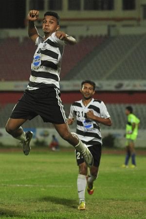 Mohammedan striker Wahed Ahmed (L) jumps into the air in celebration after scoring one of his two goals against Brothers Union in their Bangladesh Premier League encounter at the Bangabandhu National Stadium yesterday. PHOTO: STAR