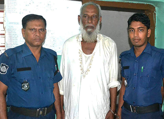 Law enforcers arrest accused war criminal Akram Hossain Khan (C) from Rajshahi on Friday. Photo: Star