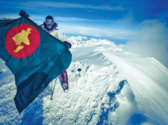 With the 1971 flag of  Bangladesh on the  summit of Denali,  highest mountain  of North America,  as the first  Bangladeshi  summiteer.  Photo: Sebastian Grau