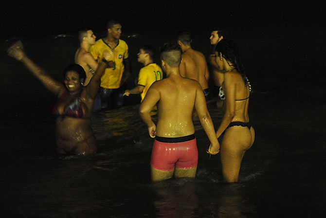 Brazilian fans celebrate in the water during the Fan Fest at Copacabana beach in Rio de Janeiro, Brazil, after the squad beat Colombia in a FIFA World Cup quarter-final football match.. Photo: Getty Images