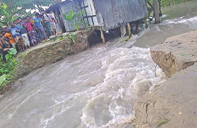 Water enters the villages in Sadar upazila through the breached portion of Bhola town protection dyke. Photo: Star