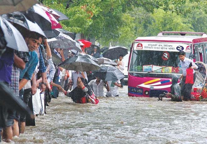 A downpour between the break of dawn and the afternoon yesterday inundated a third of Chittagong city. Vehicles got stuck in the waterlogged streets and people were wading through waist-deep water to get to places. The water eventually subsided. The photos were taken near Gate-2 of the port city. Photo: Anurup Kanti Das