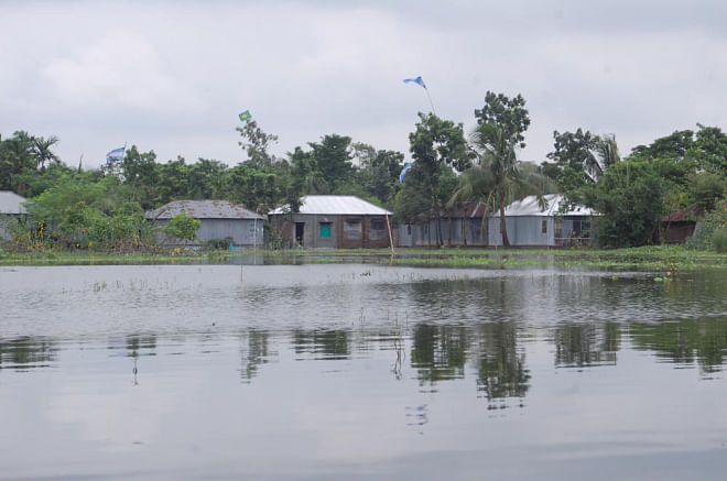 Shalgaria Forestpara in Pabna municipality remains flooded for over two weeks as the drainage is too poor to release the water during the ongoing monsoon. Photo: Star