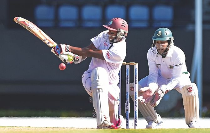 West Indies batsman Shivnarine Chanderpaul sweeps the ball during his unbeaten knock of 101 in the second and final Test against Bangladesh in St Lucia yesterday. He was third time lucky in the series after being stranded twice on 85 and 84 respectively in his previous two innings before finally getting his 30th Test ton. Photo: AFP