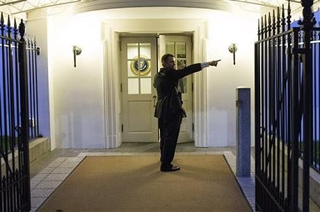 A Secret Service agent gives directions during an evacuation from the White House minutes after President Barack Obama departed for Camp David aboard Marine One on Friday, Sept. 19, 2014, in Washington. Photo: AP