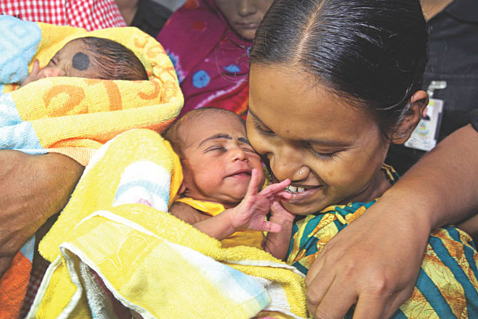 Ekhlas reunited with his mother Runa at the Rab Headquarters in the capital yesterday. The infant, seen alongside his twin, was stolen from Dhaka Medical College Hospital on August 21. Photo: Palash Khan