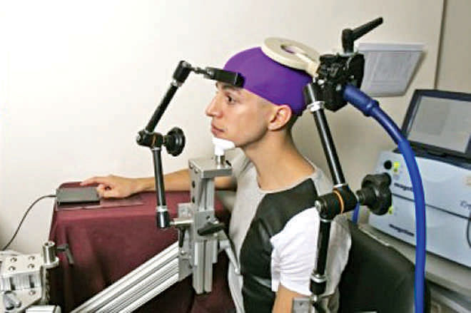 UW students Darby Losey, top, and Jose Ceballos are  positioned in two different buildings on campus as they  would be during a brain-to-brain interface demonstration.  Photo Courtesy: University of Washington