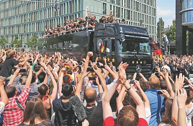 World champion Germany footballers have a ride on an open-top double-decker during a celebration parade in Berlin on Tuesday.  PHOTOS: REUTERS