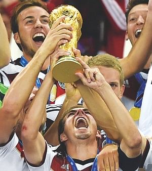 The world in his hands ... Germany captain Philipp Lahm holds aloft the World Cup trophy in company of his jubilant teammates after his side beat Argentina 1-0 in extra-time in the final of the global showpiece event at Rio de Janeiro's iconic Maracana Stadium on Sunday. Photo: afp 