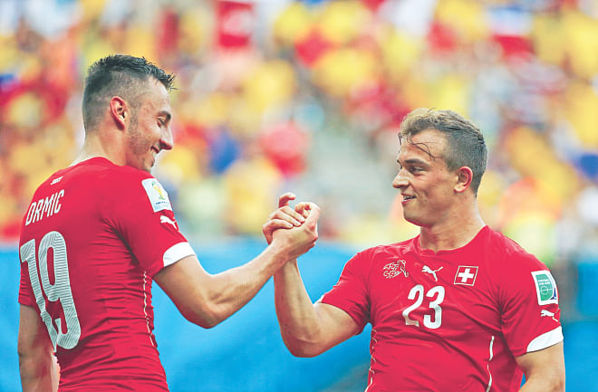 Switzerland's Xherden Shaqiri (R) celebrates one goal of his hattrick against Honduras with Josip Drmic during their World Cup Group E match at Arena Amazonia in Manaus on Wednesday. Photo: Reuters