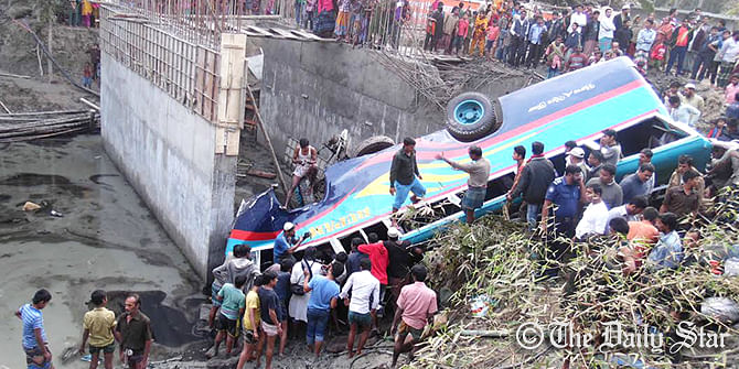 Local people try to rescue the passengers after a bus plunges into a ditch near an under construction bridge on Barisal-Jessore highway in Rajapur upazila of Jhalakathi that kills nine passengers dead and injure 20 others Tuesday afternoon. Photo: Star