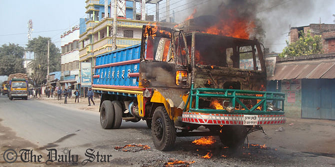 1.	A freight truck burns in flames after pro-blockade activists hurl a petrol bomb on it defying heavy security provided by the law enforcers in Shibtola area in Chapainawabganj town on Thursday. Photo: Star