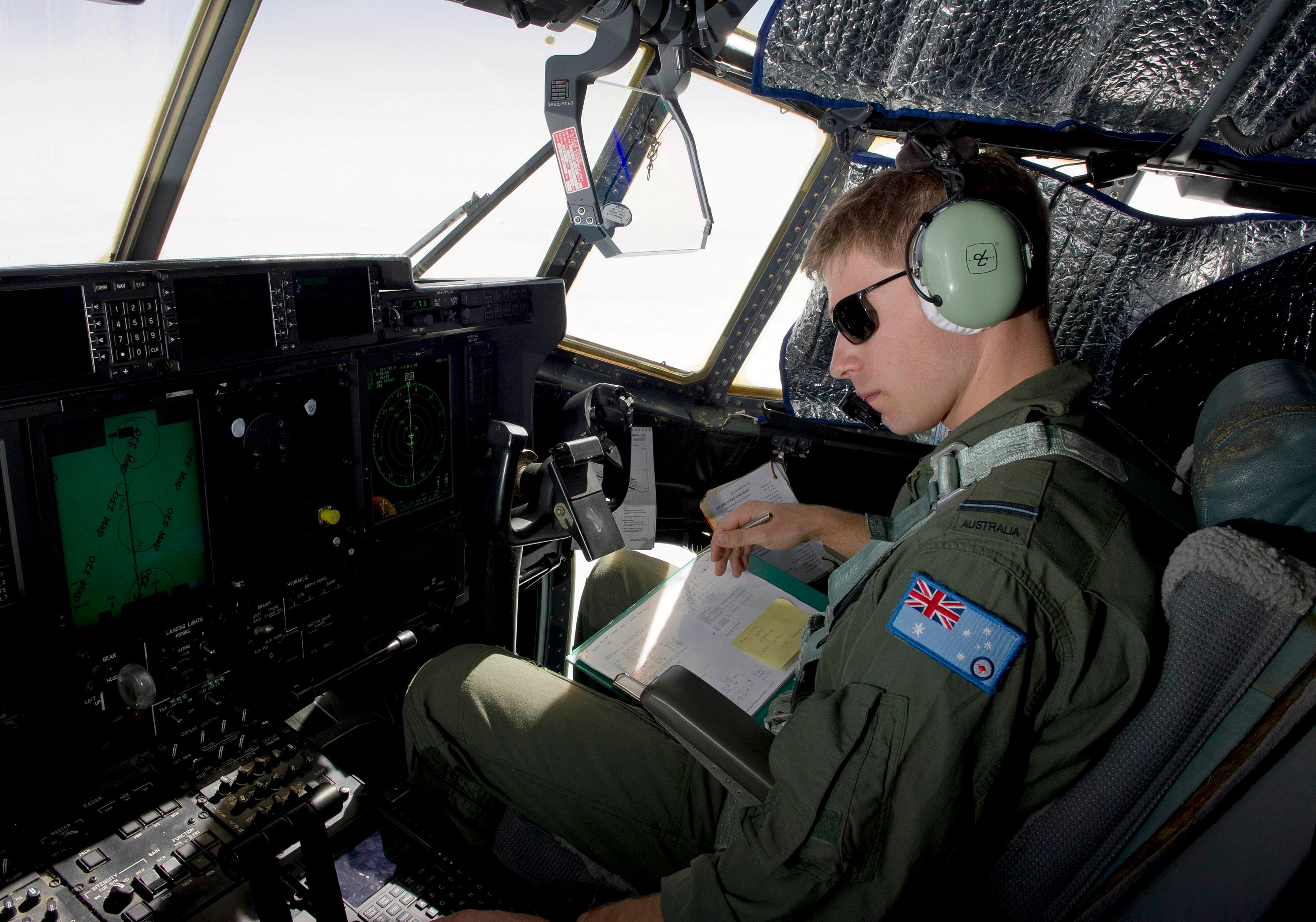Royal Australian Air Force (RAAF) Pilot Flying Officer Sam Dudman monitors the systems of a RAAF C-130J Hercules aircraft as it prepares to launch two Self Locating Data Marker Buoys in the southern Indian Ocean during the search for missing Malaysian Airlines flight MH370 in this picture released by the Australian Defence Force March 21, 2014. An international search force resumed the hunt for missing Malaysia Airlines flight MH370 in the remote southern Indian Ocean on Friday as authorities pored over satellite data to try and confirm a potential debris field. Photo: Reuters
