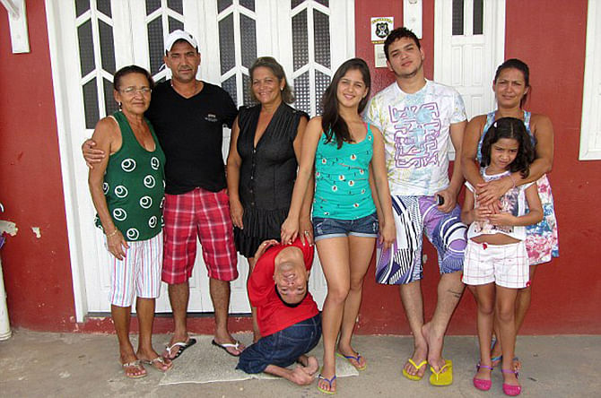 Survivor: Doctors told his mother, Maria Jose Vieira Martins (far left), to stop feeding him as a newborn as they believed he had no chance of survival (pictured with her and members of his family). Photo taken from Barcroft media