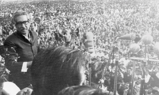 In this file photo Sheikh Mujibur Rehman approaches microphones to address rally in Dhaka.