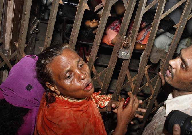 Relatives of three victims, who were shot dead, at Sonalibagh burst into tears in front of a room of Dhaka Medical College and Hospital where the bodies were kept on August 28. Photo: STAR