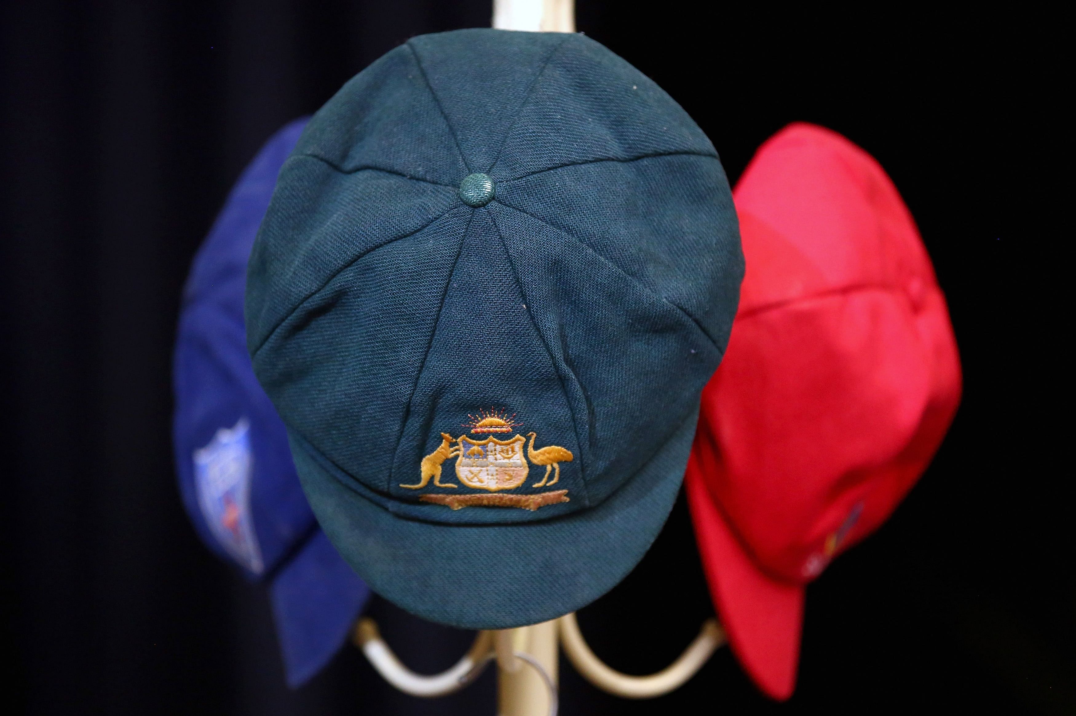 The Baggy Green and other state representative caps belonging to Australian cricketer Phillip Hughes hang near his casket before the start of his funeral service in the town of Macksville, located north of Sydney, December 3, 2014. Photo: Reuters