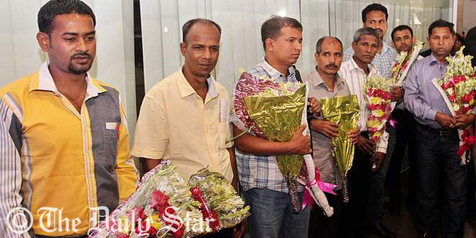 Seven Bangladeshi sailors get floral reception on their arrival at Hazrat Shahjalal International Airport in the capital Thursday morning. They were captive by Somali pirates for over three years and freed last week. Photo: Palash Khan