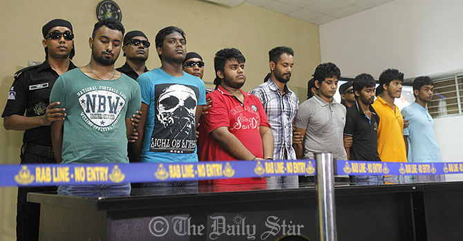 Rab-1 members produce eight people before media on Saturday after detaining them in Bashundhara residential area in the capital for their alleged involvement in killing Phulgazi upazila chairman Ekramul Haq in Feni four days back. Photo: Rashed Shumon