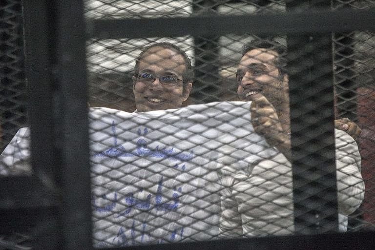 Activists Ahmed Maher and Ahmed Doma (right) show a T-shirt reading 