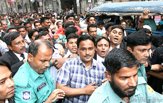 Jubo Dal President Moazzem Hossain Alal is being taken to produce before a Dhaka court on October 26. Star file photo