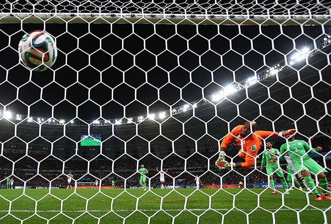 Rais M'Bolhi of Algeria fails to save a shot by Andre Schuerrle of Germany (not pictured) for Germany's first goal in extra time during the 2014 FIFA World Cup Brazil Round of 16 match between Germany and Algeria at Estadio Beira-Rio on June 30, 2014 in Porto Alegre, Brazil. Photo: Getty Images