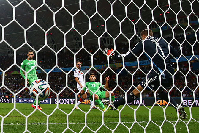 Rais M'Bolhi of Algeria fails to save a shot by Andre Schuerrle of Germany (not pictured) for Germany's first goal in extra time during the 2014 FIFA World Cup Brazil Round of 16 match between Germany and Algeria at Estadio Beira-Rio on June 30, 2014 in Porto Alegre, Brazil. Photo: Getty Images