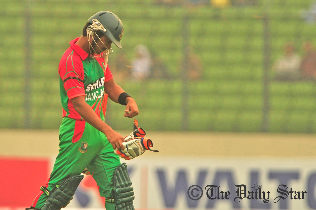 Anamul Haque (5) returning to the pavilion after falling in LBW trap. Photo: Firoz Ahmed