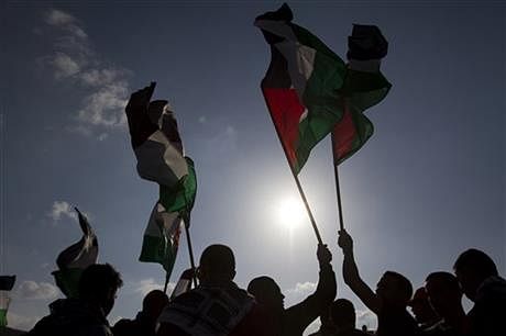  In this Friday, March 30, 2012, file photo, Arab Israeli protesters wave Palestinian flags as they gather to mark the annual Land Day event in the Arab Village of Dir Hana, northern Israel. Photo: AP