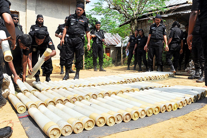 Rab-9 personnel display 14 sacks of explosives, 112 rocket launchers and 48 chargers which were recovered from Satchhari forest in Chunarughat upazila of Habiganj early today. Photo: Banglar Chokh