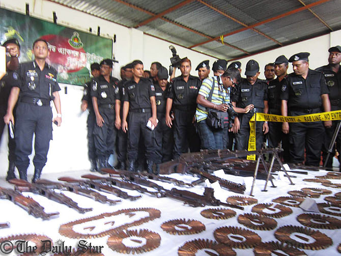 Rab personnel display arms and ammo, recovered from Satchhari forest in Habiganj, during a press briefing at the headquarters of Crime Prevention Company (CPC-2) in Srimangal upazila of Moulvibazar Tuesday. Photo: Star  