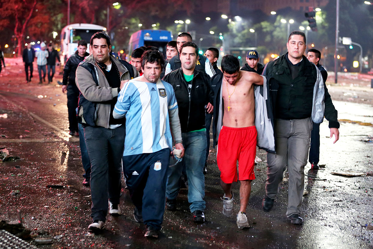 Police detain Argentine soccer fans after violence erupted near the Obelisco de Buenos Aires after their team lost to Germany 1-0 during the World Cup final on July 13, 2014 in Buenos Aires, Argentina. Photo: Getty Images