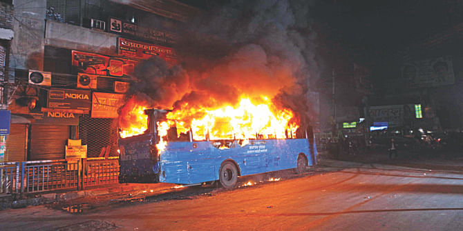 This December 28, 2014 Star photo shows a burning bus of the public administration ministry at Paltan in Dhaka after it was set on fire allegedly by pickets during a nationwide hartal sponsored by the BNP-led 20-party alliance.