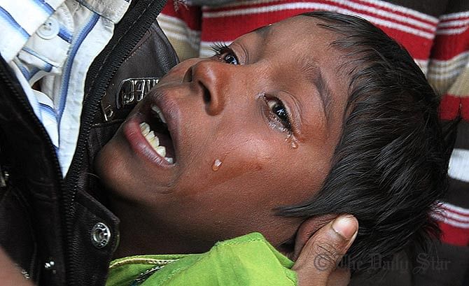 Liton, the son of Farid Miah wails at the death of his father.Farid a fruit trader, died at 9:50am, at DMCH today after being burnt in a petrol bomb attack at Shahbagh in the capital on Friday.