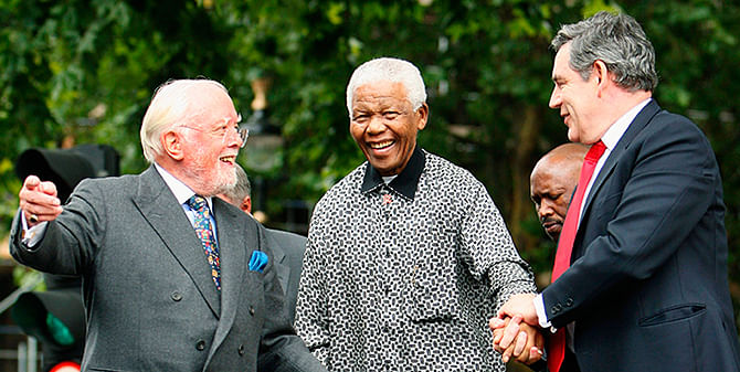 Britain's then Prime Minister Gordon Brown (R) and director Richard Attenborough assist South Africa's former President Nelson Mandela (C) to the podium, during the unveiling ceremony of a statue in Mandela's honour in London's Parliament Square, in this file picture taken August 29, 2007. Photo: Reuters