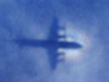 A shadow of a Royal New Zealand Air Force P-3 Orion aircraft is seen on low cloud cover while it searches for missing Malaysia Airlines Flight MH370. Photo: AP