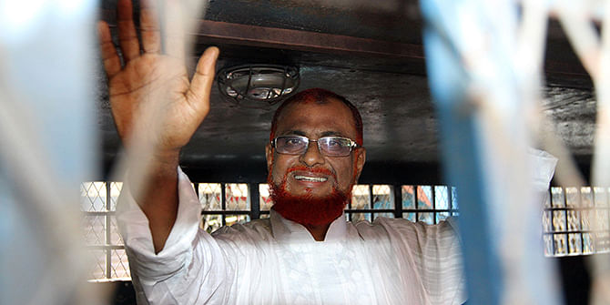 Jamaat leader Azhar waving to onlookers as he is put into a prison van after his arrest at his Moghbazar home in the capital on August 22, 2012 in connection with crimes against humanity committed during the Liberation War. Star file photo
