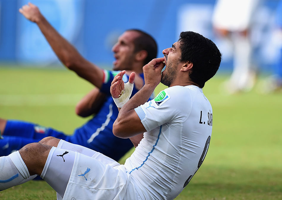 Luis Suarez of Uruguay and Giorgio Chiellini of Italy react after a clash during the match between Italy and Uruguay on June 24, 2014. Photo: Getty Images