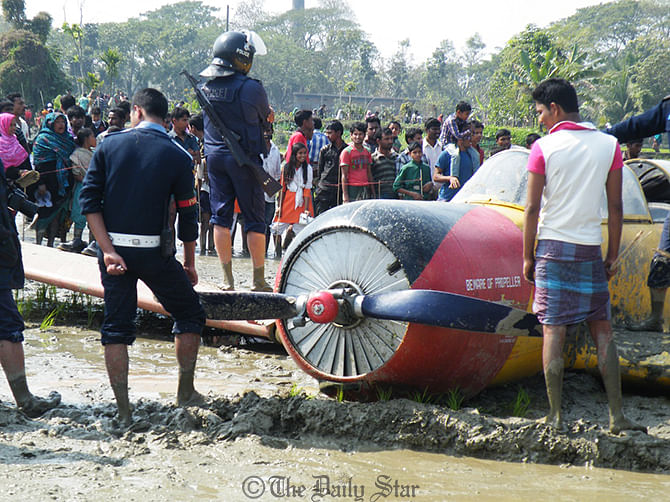 The plane hit the paddy field in Mahidia area of Jessore Sadar upazila just an hour after it took off from Jessore Airport on Thursday. Photo: Star