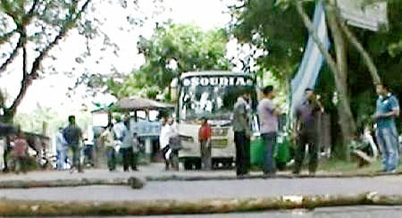 Blockaders put barricade felling logs on a road in Bandarban Saturday. Photo: TV grab