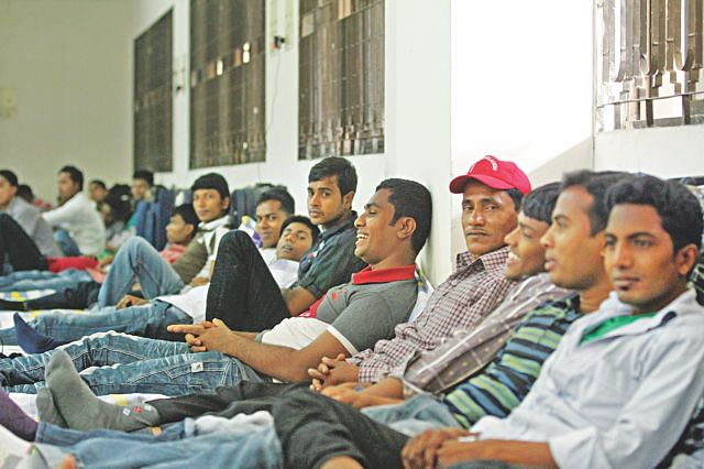 In this Star file photo, Bangladeshi workers stay at their temporary accommodation at Haji Camp in Ashkona of the capital while waiting to leave for Malaysia.