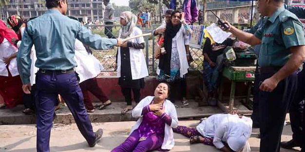 Female students of Barisal Health Technology Institute lying on the road after being baton-charged by the police during their agitation in the city on Wednesday. Photo taken from Prothom Alo