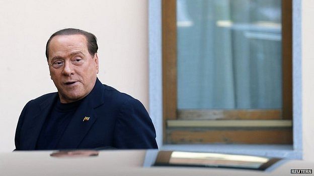 Former Italian Prime Minister Silvio Berlusconi looks on as he arrives at the Sacred Family Foundation, where he will serve part of his one-year tax fraud sentence by doing community service with the elderly, in Cesano Boscone, a small town on the outskirts of Milan May 9, 2014. Photo: Reuters