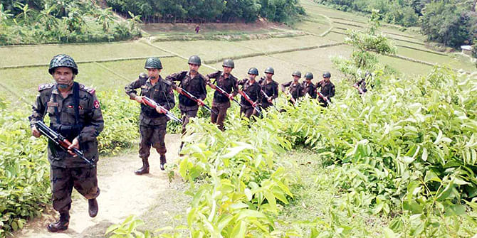 This May 30 Banglar Chokh photo shows Border Guard Bangladesh troops patrolling the Bangladesh side of the border with Myanmar at Naikkhangchhari in Bandarban.