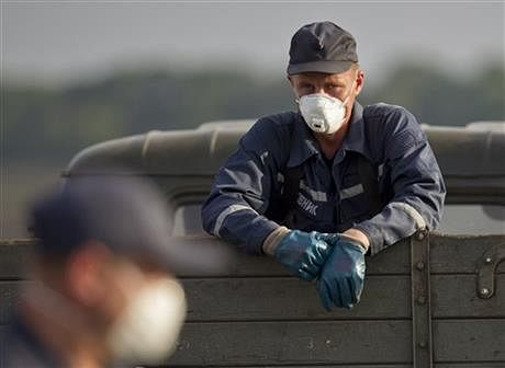 An emergency worker pauses in a truck loaded with bodies of the victims at the crash site of Malaysia Airlines Flight 17 near the village of Hrabove, eastern Ukraine, Saturday. Photo: AP