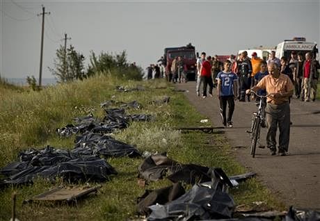 Bodies of victims are placed in plastic sacks by the side of the road at the crash site of Malaysia Airlines Flight 17 near the village of Hrabove, eastern Ukraine, Saturday, July 19. Photo: AP