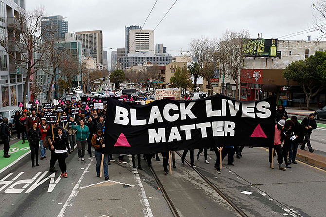 Demonstrators march on Market Street during a peaceful protest against police violence organized by the San Francisco LGBT Community Center in San Francisco, California December 24, 2014. Photo: Reuters