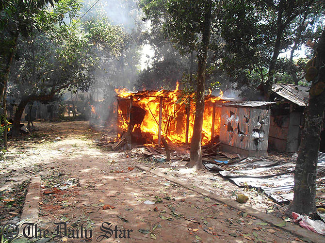 A house is set on fire during a clash between two village people in Kurigram Sadar Upazila Thursday morning. Around 50 houses and several shops of Shandarpara were burnt in the clash. Photo: Star